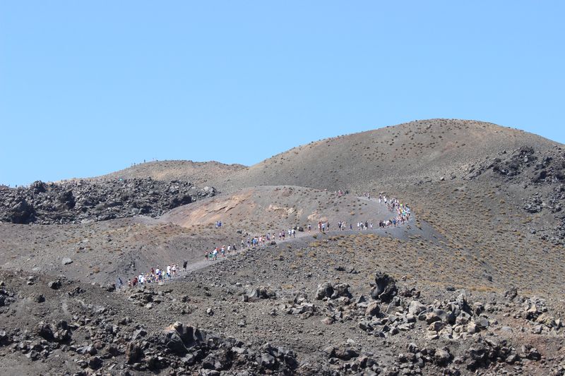 Инопланетные пейзажи: Змейка туристов на лысой горе. Остров Неа Камени, Санторини